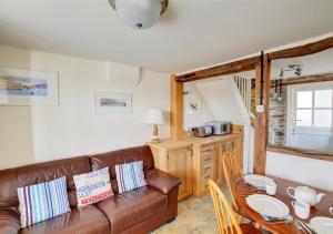 a living room with a couch and a table at 5 Seaview in Looe