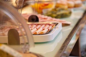 a table with a bunch of hot dogs and other foods at K+K Hotel Fenix in Prague