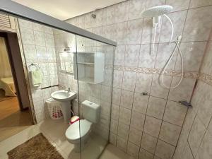 a bathroom with a shower and a toilet and a sink at Pousada Residencial - PVH in Porto Velho +29 photos