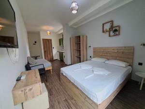 a bedroom with a large white bed and a table at Poppy Beloni in Chania Town