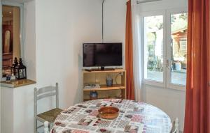 um quarto com uma mesa, uma televisão e uma janela em Beautiful Apartment In Saint-pe-sur-nivelle With Kitchen em Saint-Pée-sur-Nivelle