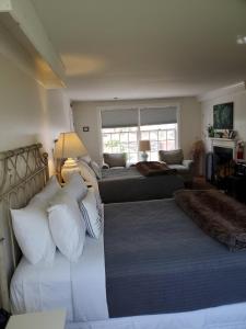 a living room with two beds and a couch at Farm Road Estate in West Dover