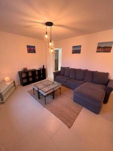 a living room with a couch and a coffee table at Grand appartement a 300M de la plage in Sainte-Maxime