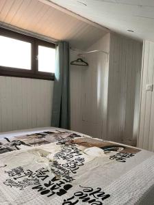 a large bed in a room with a window at L'appart de la liberté in Millau