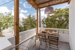 a balcony with a table and chairs on it at The Locals in Káto Potamiá