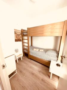 a room with two bunk beds and a table at DUPLEX IN TARIFA'S OLD TOWN in Tarifa