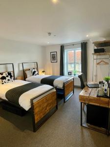 a hotel room with two beds and a window at Booking Urban at Stisted in Braintree