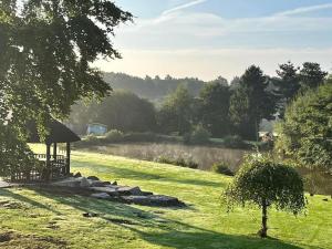 a gazebo in the middle of a grass field at Blackbrook Lodge Cabin in Turnditch