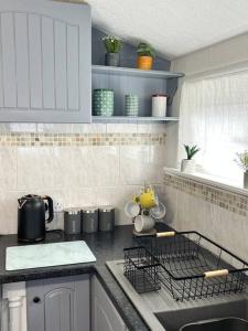 a kitchen with a sink and a counter top at Blackbrook Lodge Cabin in Turnditch