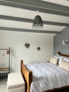 um quarto com uma cama de madeira e um tecto em Blackbrook Lodge Cabin em Turnditch