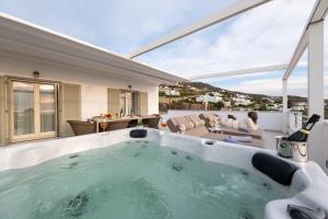 a hot tub in the backyard of a house at Panos Villa Sunset View in Parikia