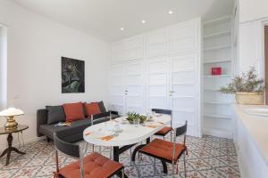 a living room with a table and a couch at A Few Steps from the Sea by Wonderful Italy in Recco