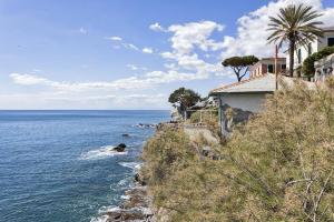 a house on a hill next to the ocean at A Few Steps from the Sea by Wonderful Italy in Recco