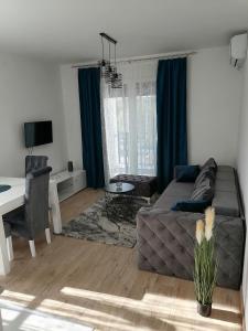 a living room with a couch and a table at Apartman Savic in Vrnjačka Banja
