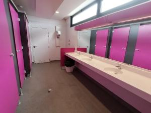 a bathroom with two sinks and purple walls at Séjour insolite sur un yacht. Bateau Hôtel à quai. in La Rochelle