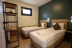 a hotel room with two beds and a ladder at Mia Mia Suites in Istanbul