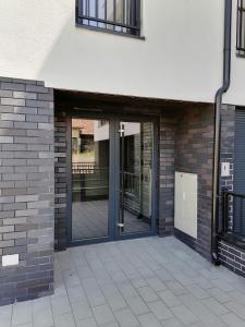 an entrance to a building with sliding glass doors at Apartman Savic in Vrnjačka Banja