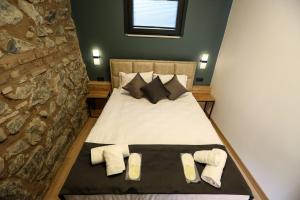 a bedroom with a bed with two towels on it at Mia Mia Suites in Istanbul