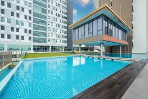 a swimming pool on the roof of a building with tall buildings at Greystone 99 Suites in Malacca
