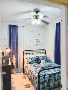 - une chambre avec un lit et un ventilateur de plafond dans l'établissement Casa Amalia Beach House, à Aguada