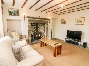 a living room with a couch and a fireplace at Covercote in Leyburn