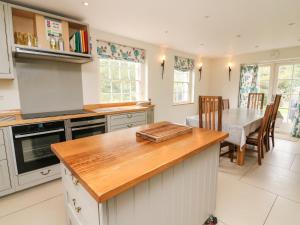 a kitchen with a table and a dining room at Covercote in Leyburn