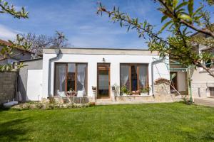 a white house with a lawn in front of it at Guests house Provence in Kavarna