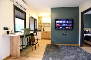 a living room with a table and a tv on a wall at Mia Mia Suites in Istanbul