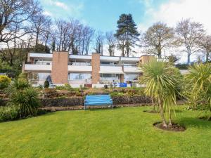 a blue bench in front of a building at Sunny View in Dawlish