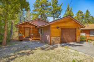 a cabin in the woods with a garage at Country Club Cabin in Big Bear City