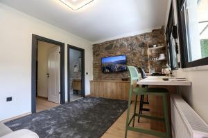 a kitchen with a table and chairs and a stone wall at Mia Mia Suites in Istanbul