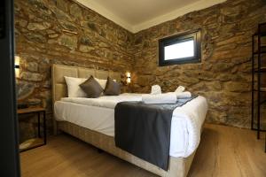 a bedroom with a bed in a stone wall at Mia Mia Suites in Istanbul