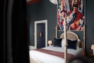 a bedroom with a canopy bed with a painting on the wall at Milsom Hotel Bath in Bath