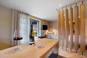 a bottle of wine and two glasses on a counter at Casa Sonngart in Parcines