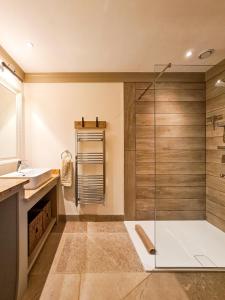 a bathroom with a glass shower and a sink at Luxury Lodge @ Ewen Barn - private 5* retreat in Cirencester