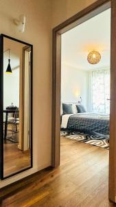 a mirror in a room with a bed and a bedroom at Charme mystique de la Chine, Free Parking in Morges