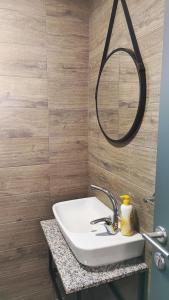 a bathroom with a sink and a mirror at Villa Natali in Ohrid