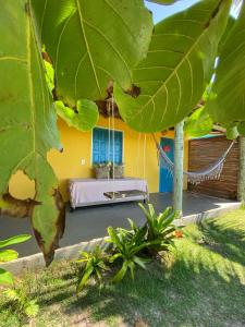a room with a hammock in front of a house at OCA Caraíva in Caraíva