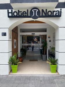 an entrance to a hotel portal with potted plants at Hotel Norai in Lloret de Mar