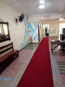 a hallway with a red carpet and a room with a table at Lolita House in Rio de Janeiro