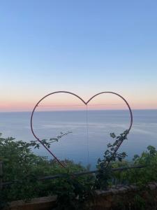 a heart frame with a view of the ocean at Apartments Villa Vanja in Budva