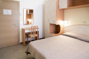 Postel nebo postele na pokoji v ubytování Hotel Martinez
