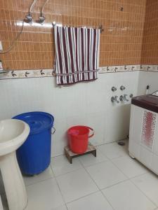 a bathroom with a toilet and a tub and a sink at A1 B&B shimla in Shimla