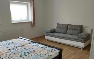 a living room with a couch and a bed at Ferienwohnung Berger in Reinhardtsdorf