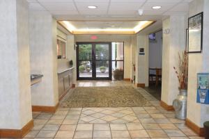 a hallway of a hospital with a door and a hallwayngth at Howard Johnson by Wyndham Tifton GA I-75 in Tifton