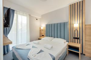 Postel nebo postele na pokoji v ubytování HOTEL TALIA