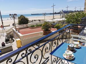 a blue table on a balcony with a view of the beach at Le Bel Horizon - Face Mer in Les Sables-dʼOlonne