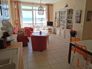 a living room with a view of the ocean at Le Bel Horizon - Face Mer in Les Sables-dʼOlonne +16 photos