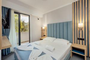 Postel nebo postele na pokoji v ubytování HOTEL TALIA