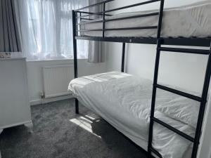 a bedroom with two bunk beds and a bed at Quaint 2 Bed Village Retreat in Pevensey